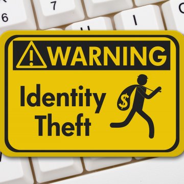 id watchdog identity theft protection yellow sign identity theft warning on white computer keyboard